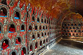 Myanmar, Burma, Nyaungshwe. Small Buddhas set into the temple wall, Shwe Yaunghwe Kyaung monastery, near Inle Lake. 